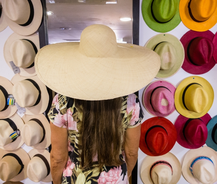 Trying on one of many hat styles at Artesanias de Colombia in El Centro (Old City) Cartagena, Colombia