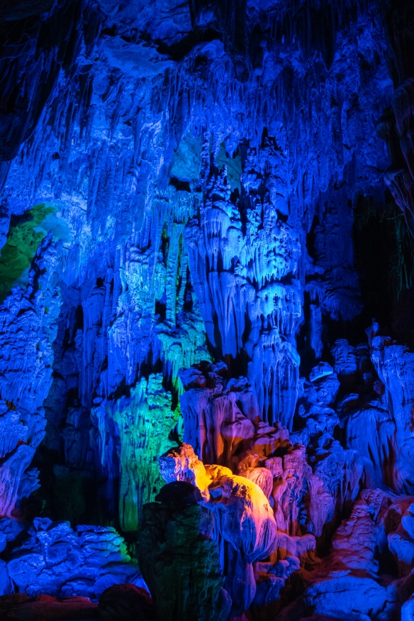 One of the first “rooms” that we walked through on our tour of Reed Flute Cave, a water-eroded cave that is a spectacular world of various stalactites, stone pillars &amp; rock formations created by carbonate deposition, illuminated by colored lighting